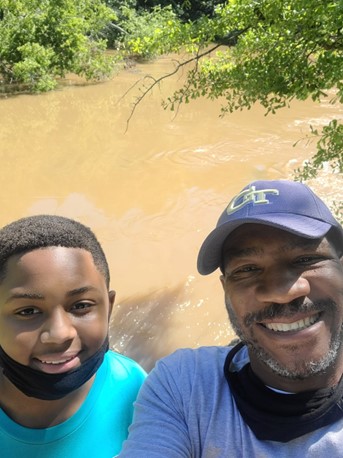 Les Canty, right, and a participant from the At-Promise Youth & Community Center West enjoy a nature hike.